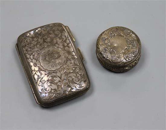 A silver cigarette case and a silver pill box.